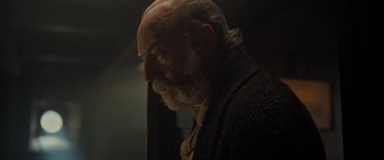 Movie still from “The Last Voyage of the Demeter” (2023), directed by André Øvredal – An old man with a beard is looking into the distance; Close Up shot, Low angle