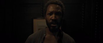 Movie still from “The Last Voyage of the Demeter” (2023), directed by André Øvredal – A person with a beard looking at the camera; Close Up shot, High angle