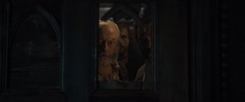 Movie still from “The Last Voyage of the Demeter” (2023), directed by André Øvredal – A man looking at himself in a mirror; Close Up shot, Over the shoulder angle