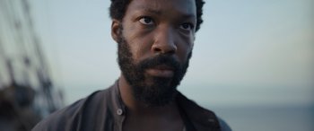 Movie still from “The Last Voyage of the Demeter” (2023), directed by André Øvredal – A person with a beard; Close Up shot, Low angle