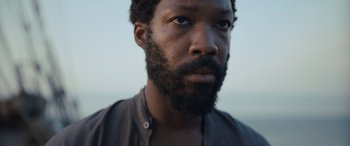 Movie still from “The Last Voyage of the Demeter” (2023), directed by André Øvredal – A person with a beard; Close Up shot, Low angle