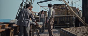 Movie still from “The Last Voyage of the Demeter” (2023), directed by André Øvredal – A group of people standing on top of a wooden boat; Wide shot, High angle
