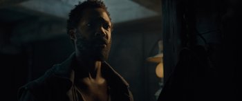 Movie still from “The Last Voyage of the Demeter” (2023), directed by André Øvredal – A person with a beard looking at the camera; Close Up shot, Over the shoulder angle