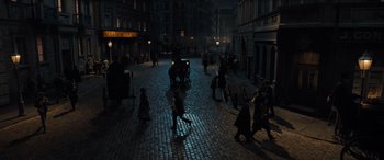Movie still from “The Last Voyage of the Demeter” (2023), directed by André Øvredal – A group of people walking down a street at night; Extreme Wide shot, High angle