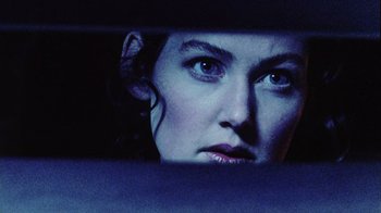 Movie still from “Dog Soldiers” (2002), directed by Neil Marshall – A person looking out of a car window; Close Up shot, Low angle