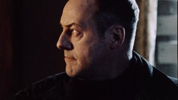 Movie still from “Dog Soldiers” (2002), directed by Neil Marshall – A person looking to his left; Close Up shot, Low angle