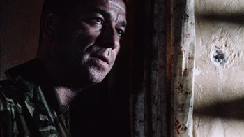 Movie still from “Dog Soldiers” (2002), directed by Neil Marshall – A person looking out a window; Close Up shot, Low angle