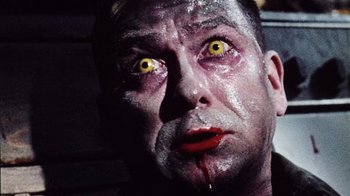 Movie still from “Dog Soldiers” (2002), directed by Neil Marshall – A person's face with blood on his face; Close Up shot, Low angle