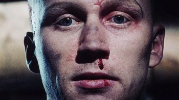 Movie still from “Dog Soldiers” (2002), directed by Neil Marshall – A person with blood on his face; Extreme Close Up shot, Overhead angle