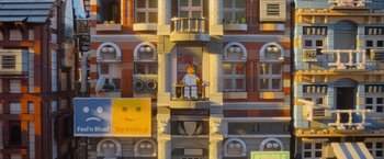 Movie still from “The Lego Movie” (2014), directed by Phil Lord – A lego man sitting on a balcony; Extreme Wide shot, Low angle