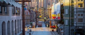 Movie still from “The Lego Movie” (2014), directed by Phil Lord – A street scene with a toy car and buildings in the background; Extreme Wide shot, Low angle
