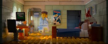 Movie still from “The Lego Movie” (2014), directed by Phil Lord – A lego figure is sitting in a room with furniture; Wide shot, High angle