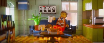 Movie still from “The Lego Movie” (2014), directed by Phil Lord – A man sitting on a blue couch with a coffee mug; Wide shot, Over the shoulder angle