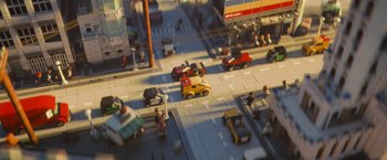 Movie still from “The Lego Movie” (2014), directed by Phil Lord – A toy model of a city street with cars and pedestrians; Extreme Wide shot, High angle