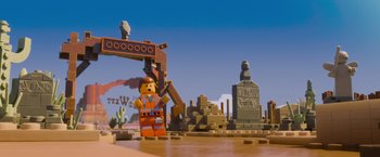 Movie still from “The Lego Movie” (2014), directed by Phil Lord – A lego construction worker is standing in front of a pile of rubble; Extreme Wide shot, Over the shoulder angle