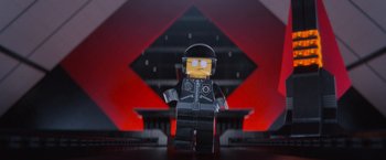 Movie still from “The Lego Movie” (2014), directed by Phil Lord – A lego figure wearing a black helmet and a black jacket; Extreme Close Up shot, Low angle