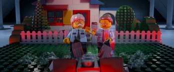 Movie still from “The Lego Movie” (2014), directed by Phil Lord – A couple of lego men standing next to each other on top of a field; Close Up shot, Over the shoulder angle
