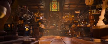 Movie still from “The Lego Movie” (2014), directed by Phil Lord – A room filled with lots of wooden furniture and a stained - glass window; Wide shot, Low angle
