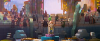 Movie still from “The Lego Movie” (2014), directed by Phil Lord – A toy figure of a man with a green star on his head; Extreme Close Up shot, Over the shoulder angle