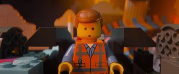 Movie still from “The Lego Movie” (2014), directed by Phil Lord – A lego man that is sitting in a chair; Close Up shot, Overhead angle