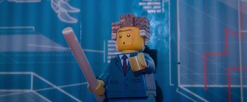 Movie still from “The Lego Movie” (2014), directed by Phil Lord – A lego man that is wearing a suit; Close Up shot, Over the shoulder angle