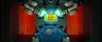 Movie still from “The Lego Movie” (2014), directed by Phil Lord – A lego man with a sad face in front of a red wall; Close Up shot, Overhead angle