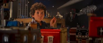 Movie still from “The Lego Movie” (2014), directed by Phil Lord – A young boy sitting in front of a toy train set; Close Up shot, Over the shoulder angle