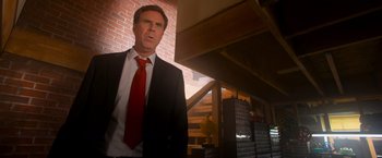 Movie still from “The Lego Movie” (2014), directed by Phil Lord – A man in a suit and tie standing in a room; Medium shot, Low angle