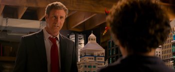 Movie still from “The Lego Movie” (2014), directed by Phil Lord – A man wearing a suit and tie standing next to a building; Medium shot, Over the shoulder angle
