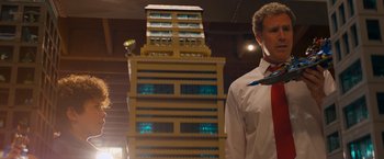 Movie still from “The Lego Movie” (2014), directed by Phil Lord – A man standing in front of a building made out of legos; Medium shot, Low angle