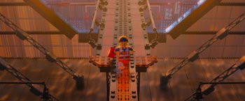 Movie still from “The Lego Movie” (2014), directed by Phil Lord – A lego construction worker sitting on top of a bridge; Extreme Wide shot, Overhead angle