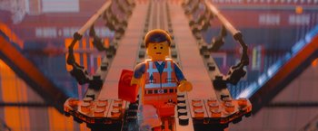 Movie still from “The Lego Movie” (2014), directed by Phil Lord – A lego man that is standing on a track; Medium shot, Low angle