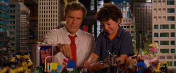 Movie still from “The Lego Movie” (2014), directed by Phil Lord – A man and a boy are playing with legos; Medium shot, Over the shoulder angle