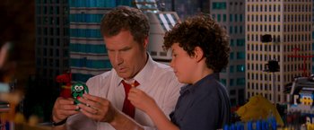 Movie still from “The Lego Movie” (2014), directed by Phil Lord – A man and a young boy looking at a cell phone; Close Up shot, Over the shoulder angle