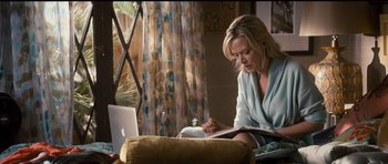 Movie still from “The Lincoln Lawyer” (2011), directed by Brad Furman – A woman sitting in front of a computer on a couch; Medium shot, High angle