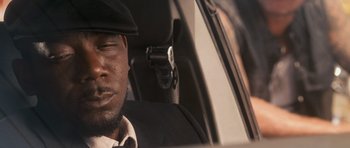 Movie still from “The Lincoln Lawyer” (2011), directed by Brad Furman – A person sitting in a car; Close Up shot, Low angle