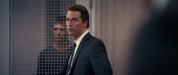 Movie still from “The Lincoln Lawyer” (2011), directed by Brad Furman – A person wearing a suit and tie; Close Up shot, Over the shoulder angle