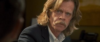 Movie still from “The Lincoln Lawyer” (2011), directed by Brad Furman – A man with long hair and a mustache; Close Up shot, Over the shoulder angle