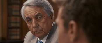 Movie still from “The Lincoln Lawyer” (2011), directed by Brad Furman – An older man wearing a suit and tie looking at a younger man; Close Up shot, Over the shoulder angle