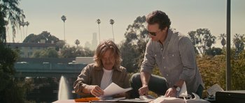 Movie still from “The Lincoln Lawyer” (2011), directed by Brad Furman – Two men sitting at a table looking at papers; Medium shot, Over the shoulder angle