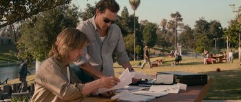 Movie still from “The Lincoln Lawyer” (2011), directed by Brad Furman – Two men sitting at a picnic table looking at papers; Medium shot, Over the shoulder angle