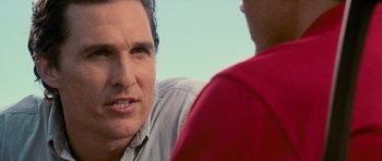 Movie still from “The Lincoln Lawyer” (2011), directed by Brad Furman – A man talking to another man in a red shirt; Close Up shot, Over the shoulder angle