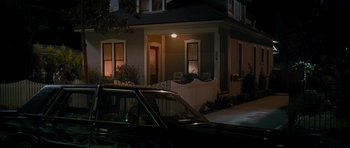 Movie still from “The Lincoln Lawyer” (2011), directed by Brad Furman – A car parked in front of a house at night; Wide shot, High angle