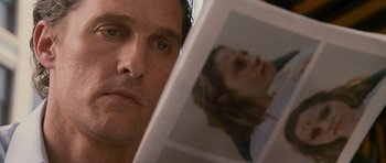 Movie still from “The Lincoln Lawyer” (2011), directed by Brad Furman – A person reading a magazine; Close Up shot, Over the shoulder angle
