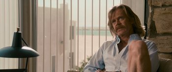 Movie still from “The Lincoln Lawyer” (2011), directed by Brad Furman – An older man sitting in a chair in front of a window; Close Up shot, Over the shoulder angle