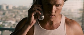 Movie still from “The Lincoln Lawyer” (2011), directed by Brad Furman – A person talking on a cell phone; Close Up shot, Low angle
