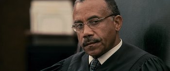 Movie still from “The Lincoln Lawyer” (2011), directed by Brad Furman – A man in a black robe and a tie; Close Up shot, High angle