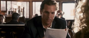 Movie still from “The Lincoln Lawyer” (2011), directed by Brad Furman – A person sitting at a table with papers; Close Up shot, Over the shoulder angle