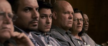 Movie still from “The Lincoln Lawyer” (2011), directed by Brad Furman – A group of men sitting next to each other in a room; Close Up shot, Over the shoulder angle