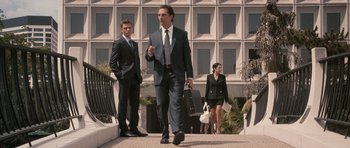 Movie still from “The Lincoln Lawyer” (2011), directed by Brad Furman – A man in a suit and tie walking down a sidewalk; Wide shot, Low angle